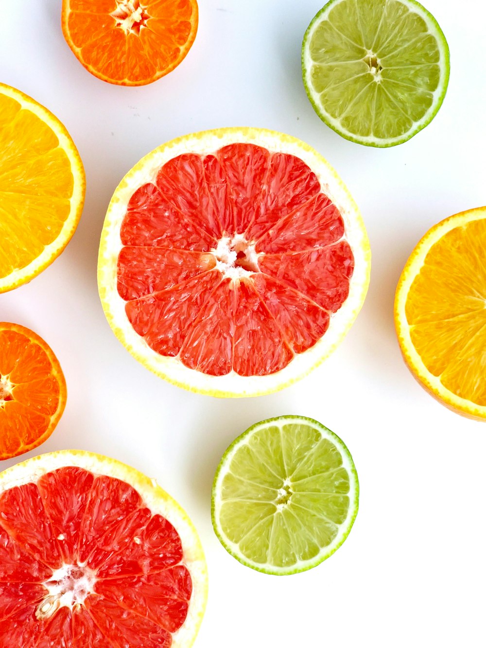 a group of grapefruits and limes cut in half