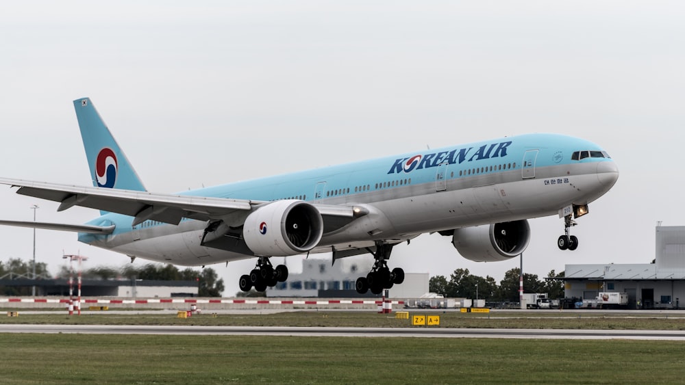 a korean air jet taking off from an airport runway