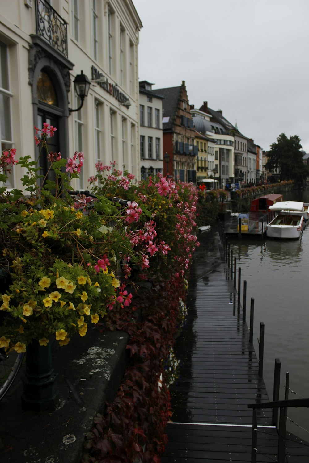 a row of buildings along a river with boats in the water