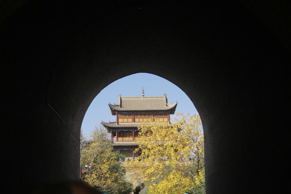 a view of a building through a tunnel