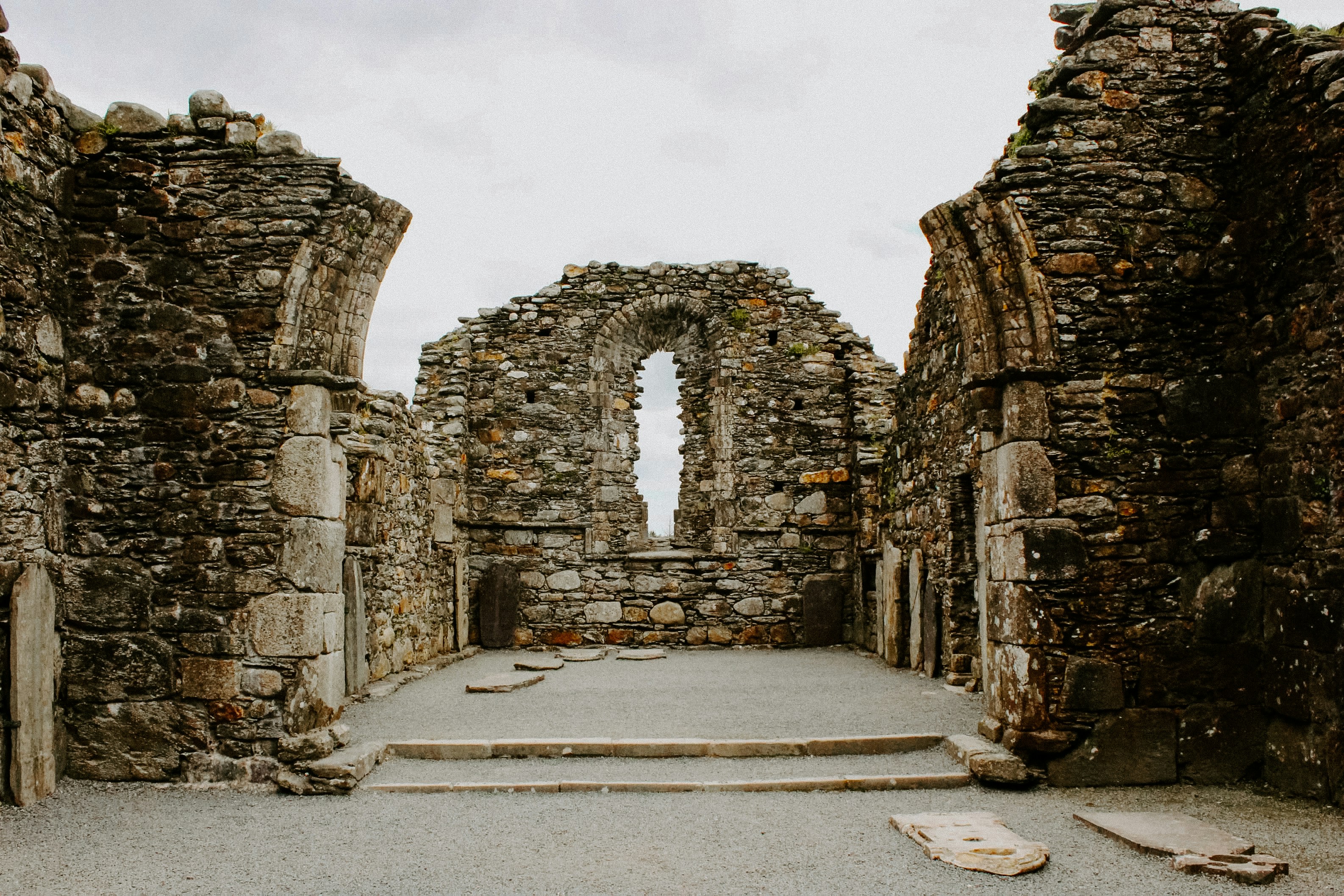 a stone building with a doorway and steps leading to it