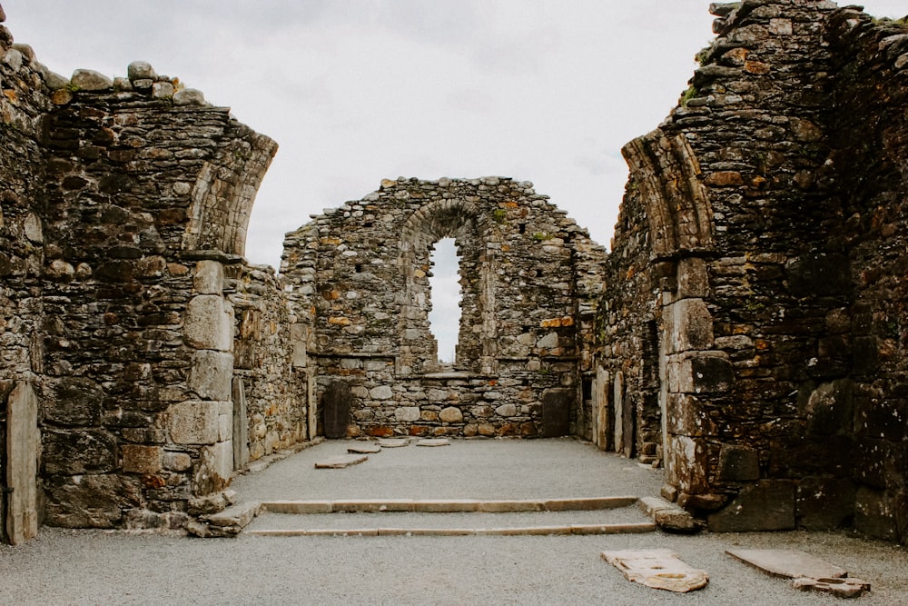 a stone building with a doorway and steps leading to it