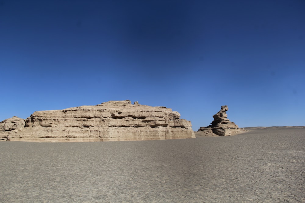 a large rock formation in the middle of a desert