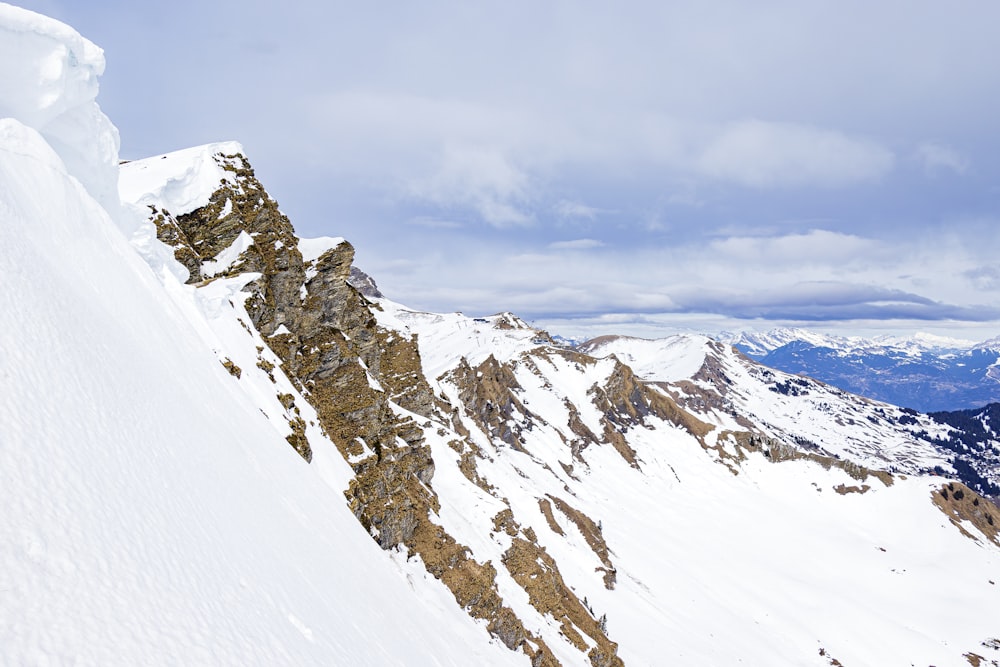 a man riding skis down the side of a snow covered mountain