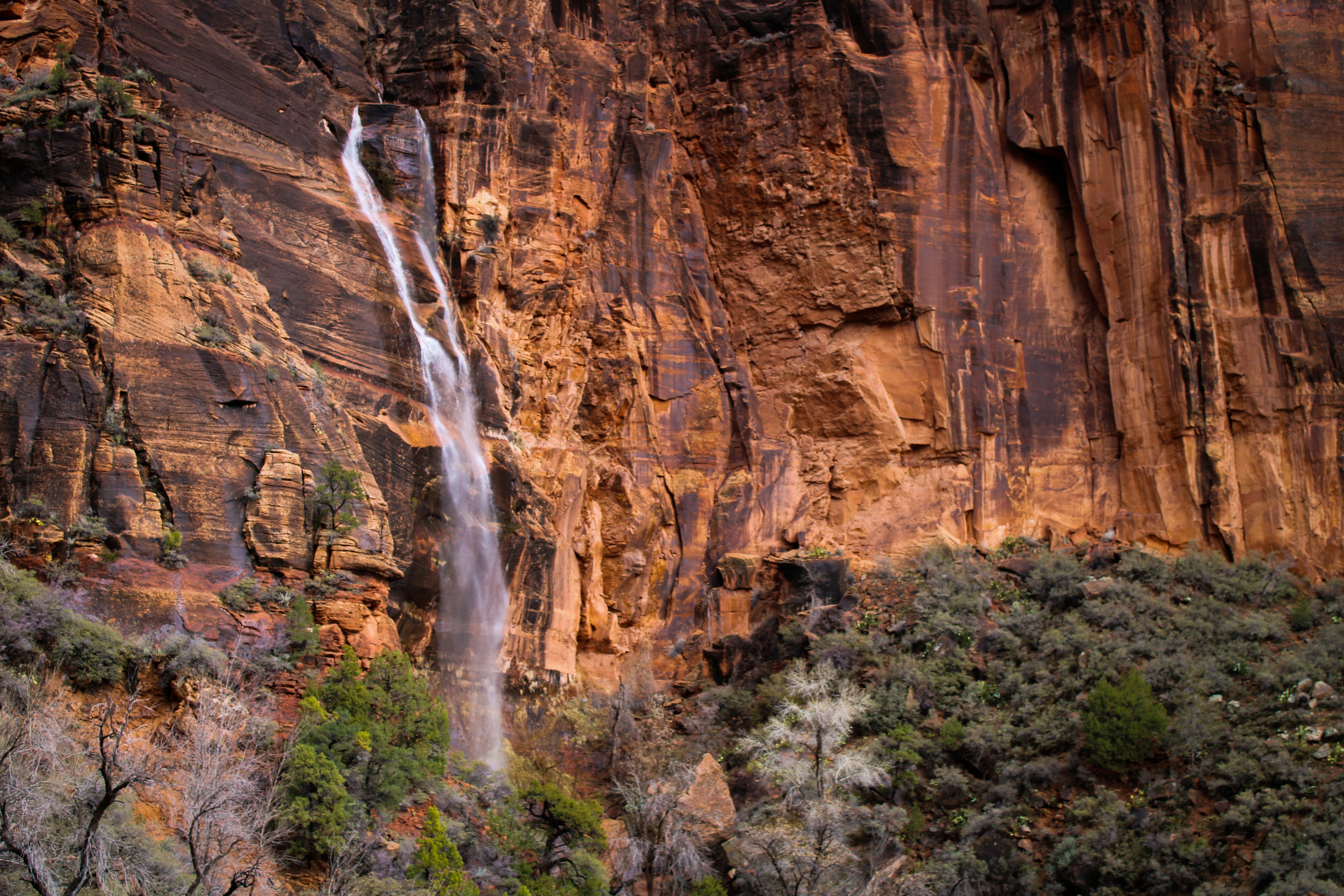 a large waterfall in the middle of a mountain