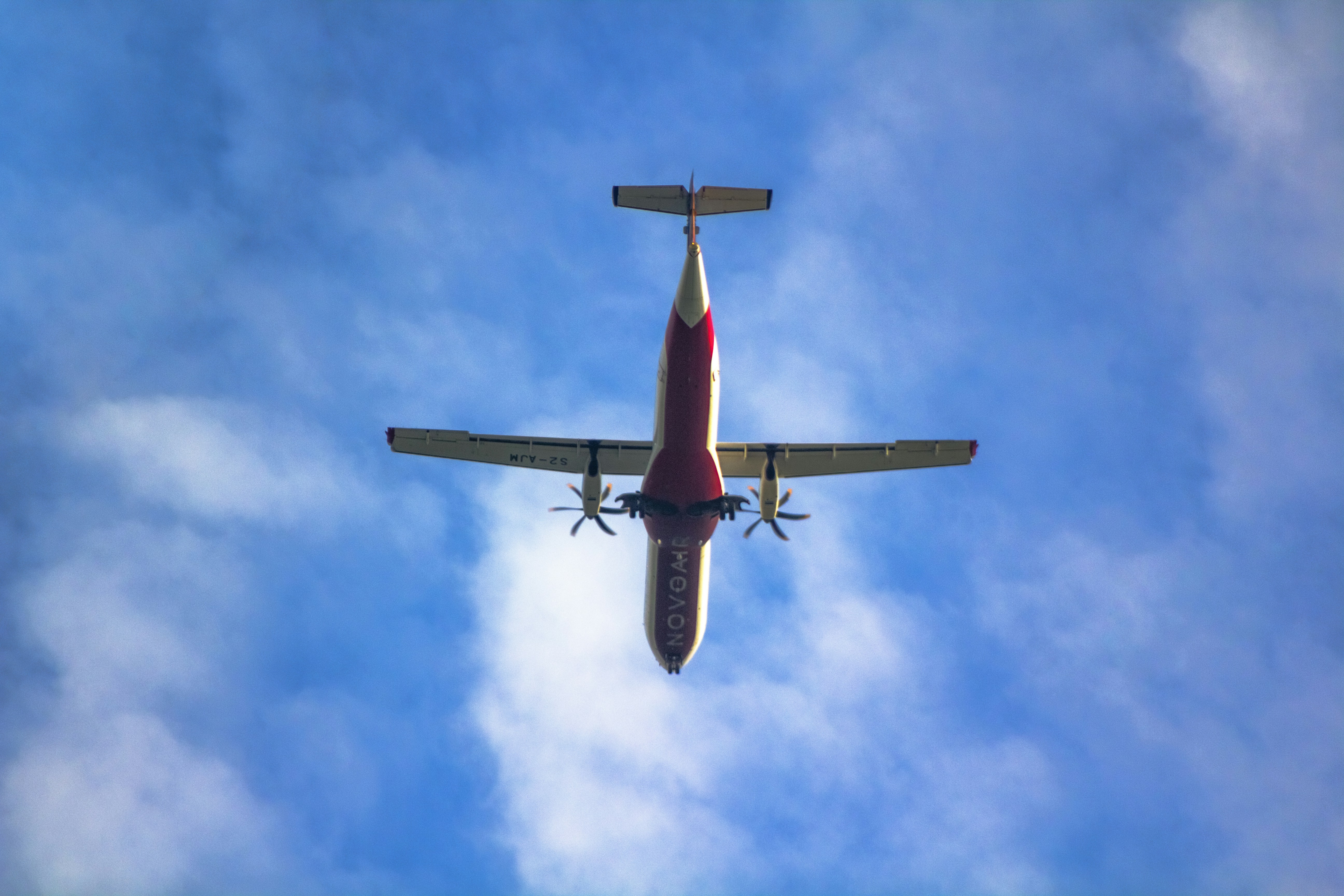 an airplane is flying through the blue sky, Airplane flying in blue skies! NovoAir 72-500