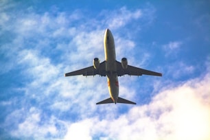 a large jetliner flying through a blue cloudy sky