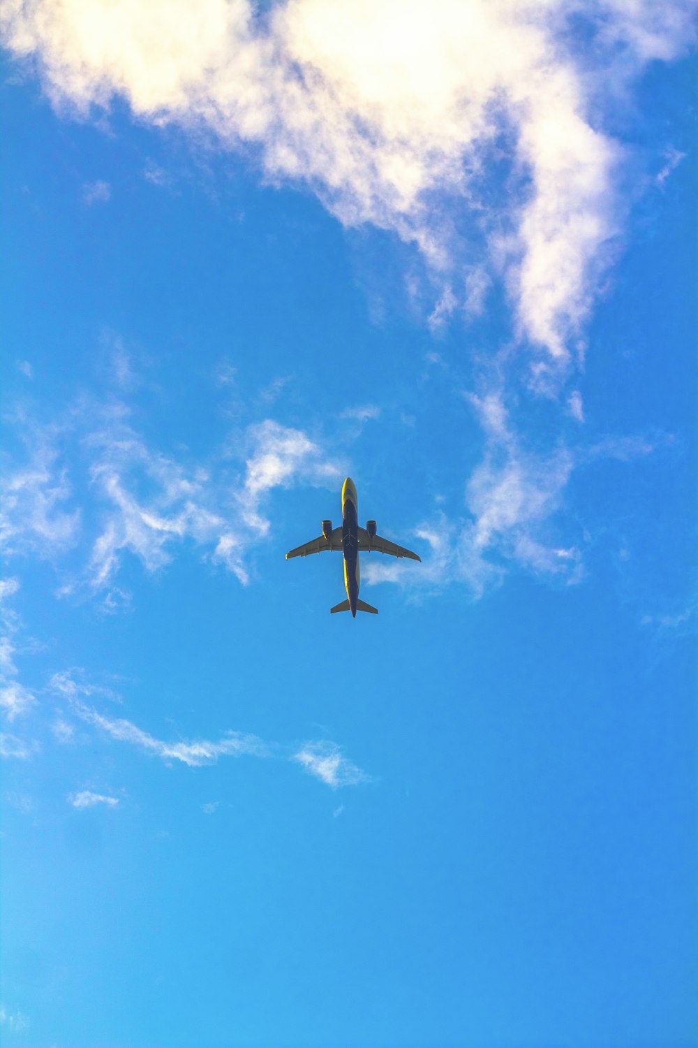 an airplane is flying through the blue sky