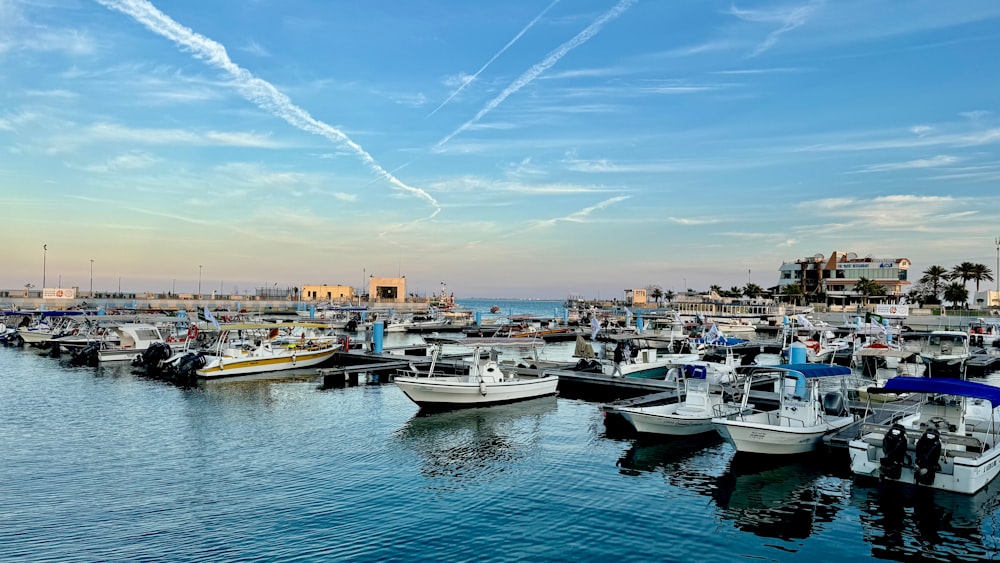 a harbor filled with lots of boats under a blue sky