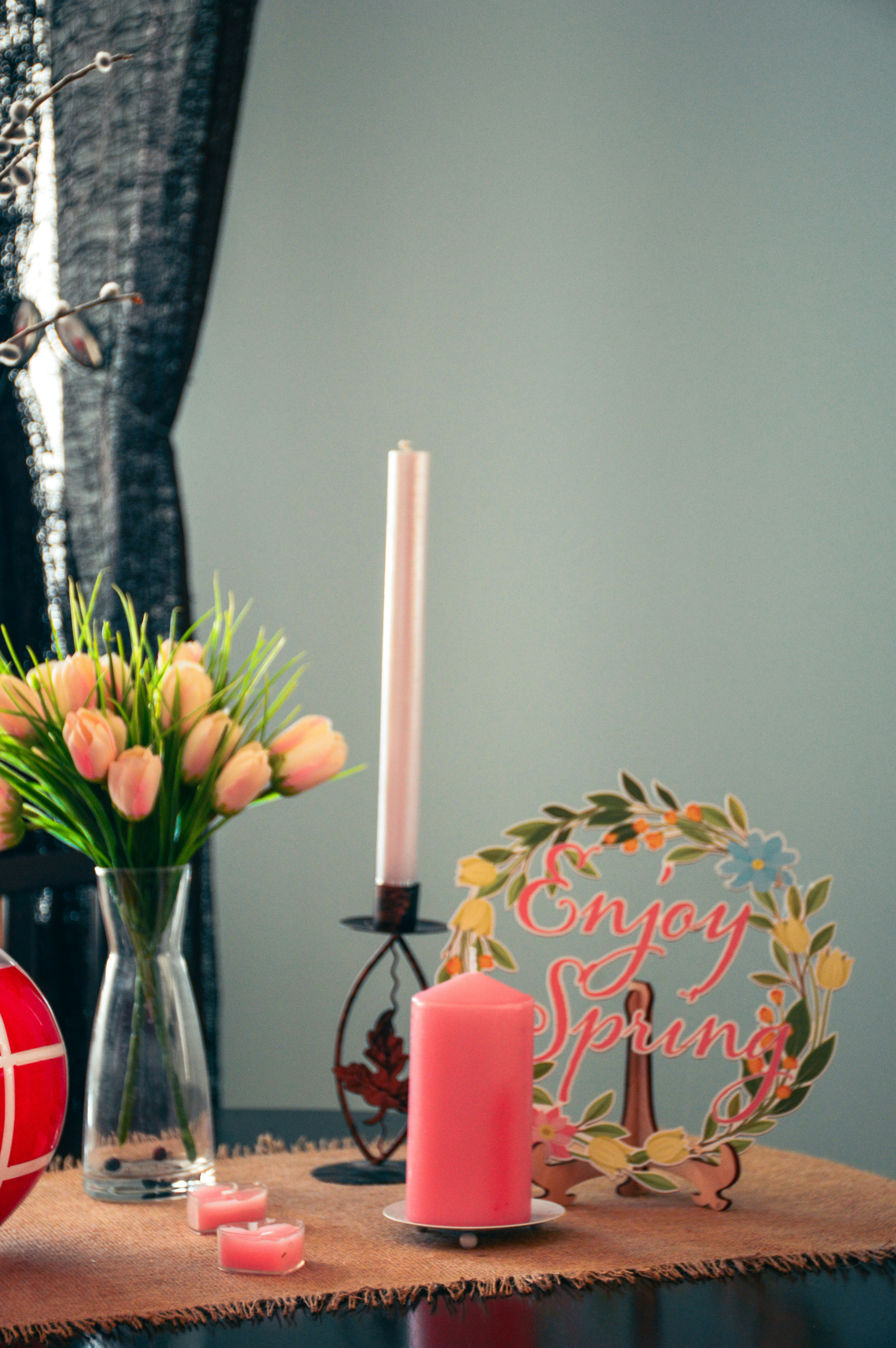a table topped with a vase filled with flowers and candles