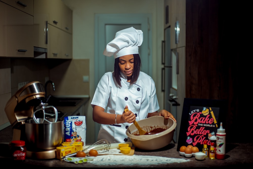 a woman in a chef's outfit preparing food in a kitchen