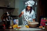 a woman in a chef's outfit is making food