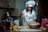 a woman in a chef's outfit is making food