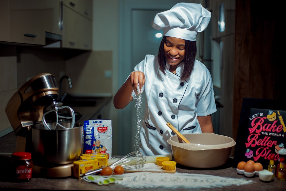 a woman in a chef's outfit is making food