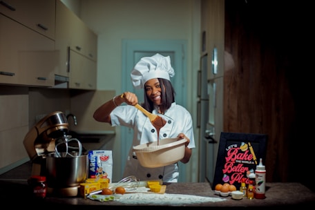 a woman in a chef's hat holding a wooden spoon