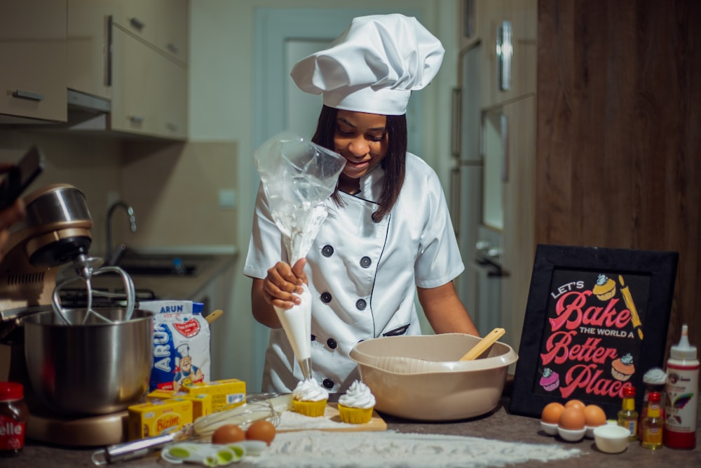 a woman in a chef's outfit preparing food in a kitchen