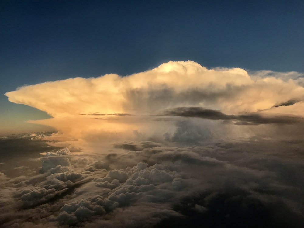 a very large cloud in the sky above some clouds