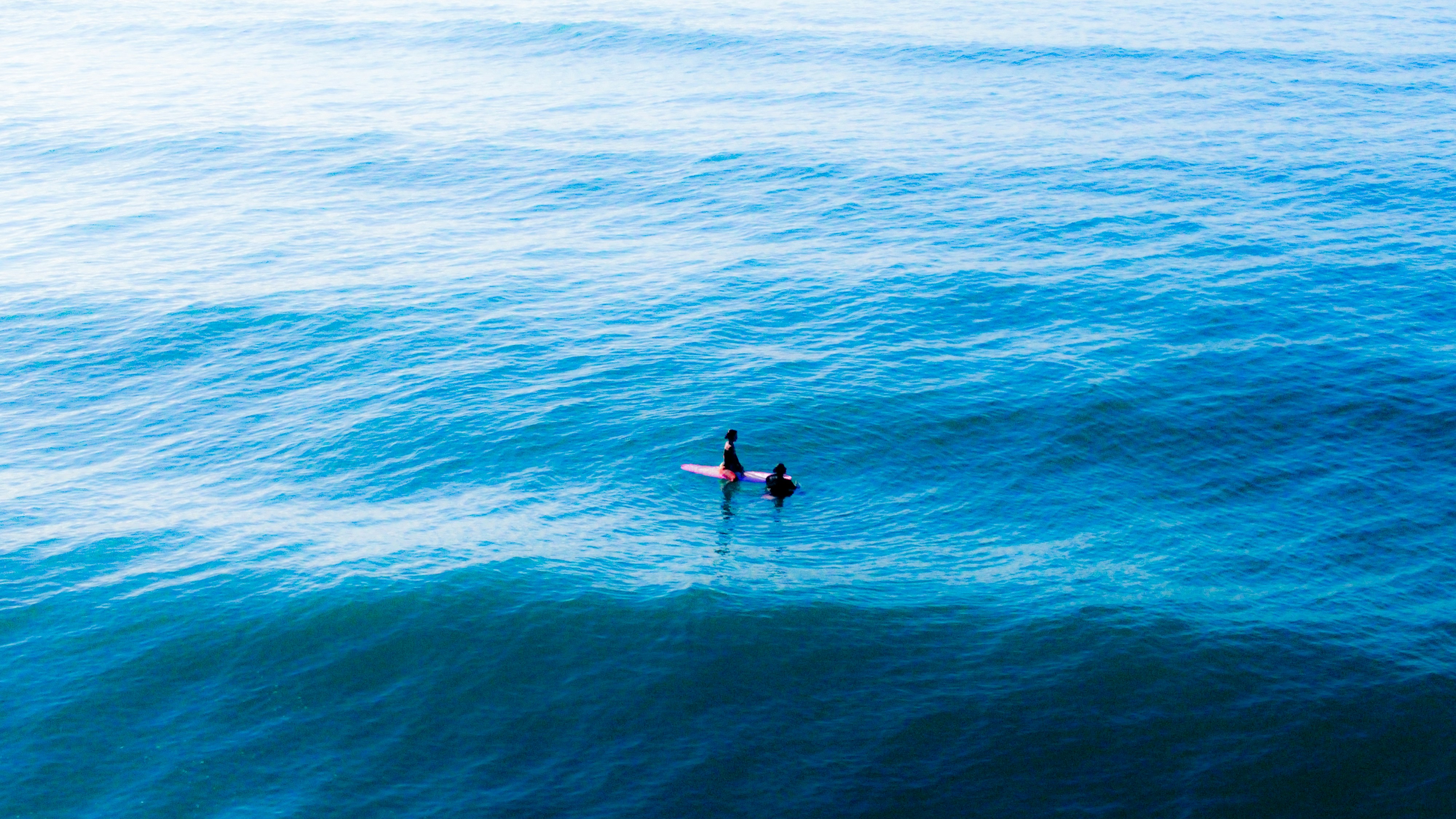 a person on a surfboard in the middle of the ocean