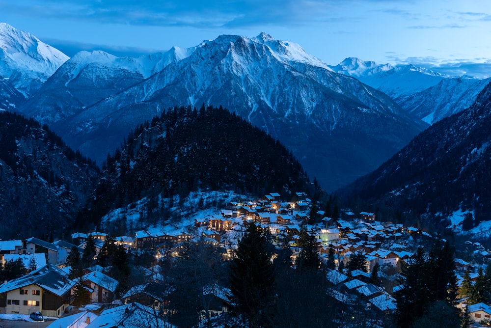 a village in the mountains covered in snow