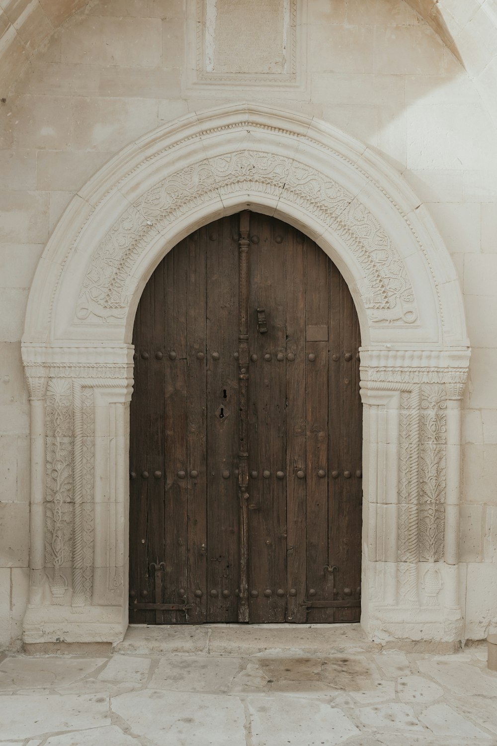 a large wooden door sitting inside of a stone building