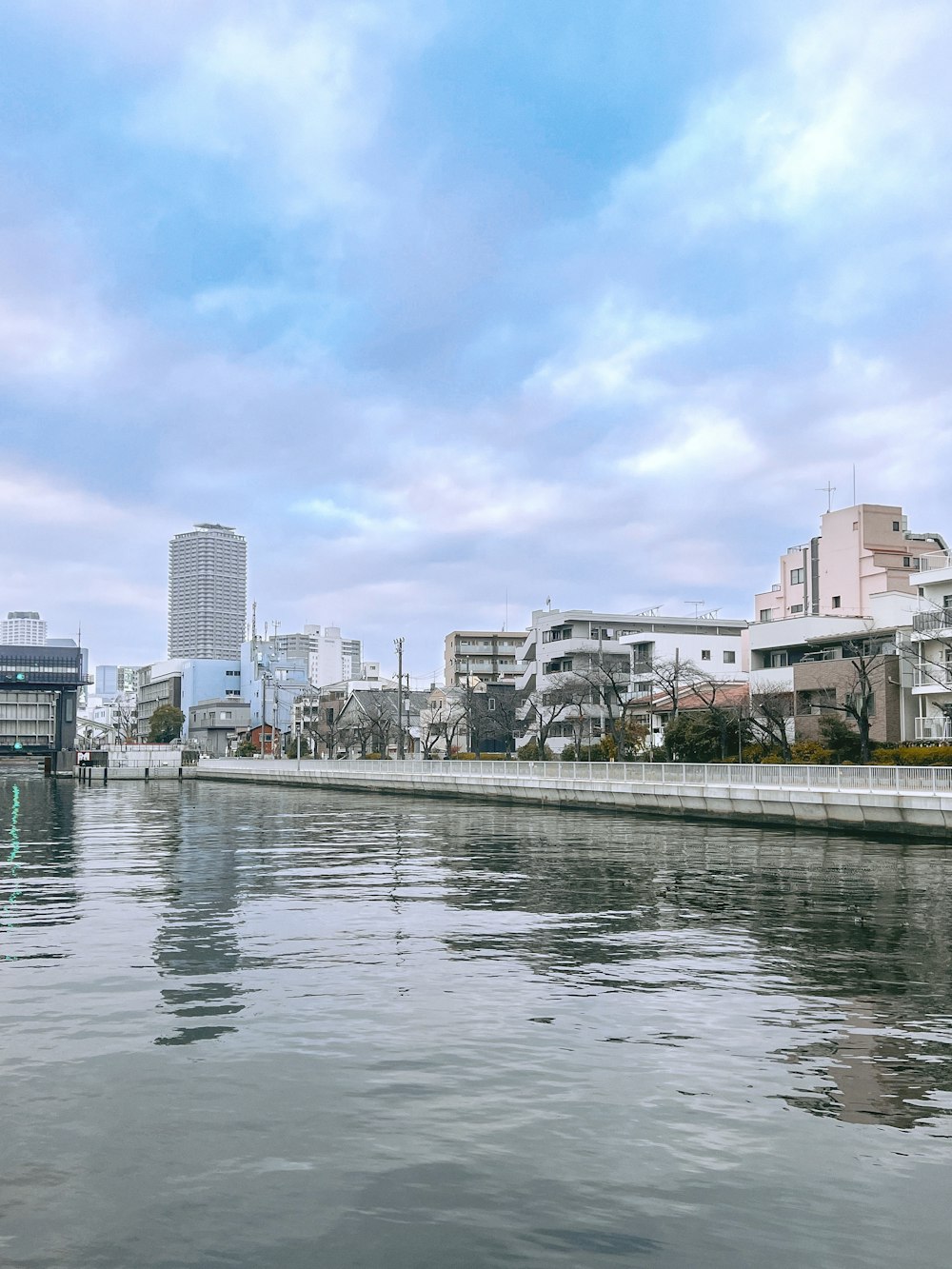 a body of water with buildings in the background