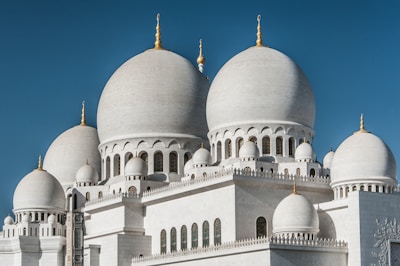 a large white building with a clock on it's side