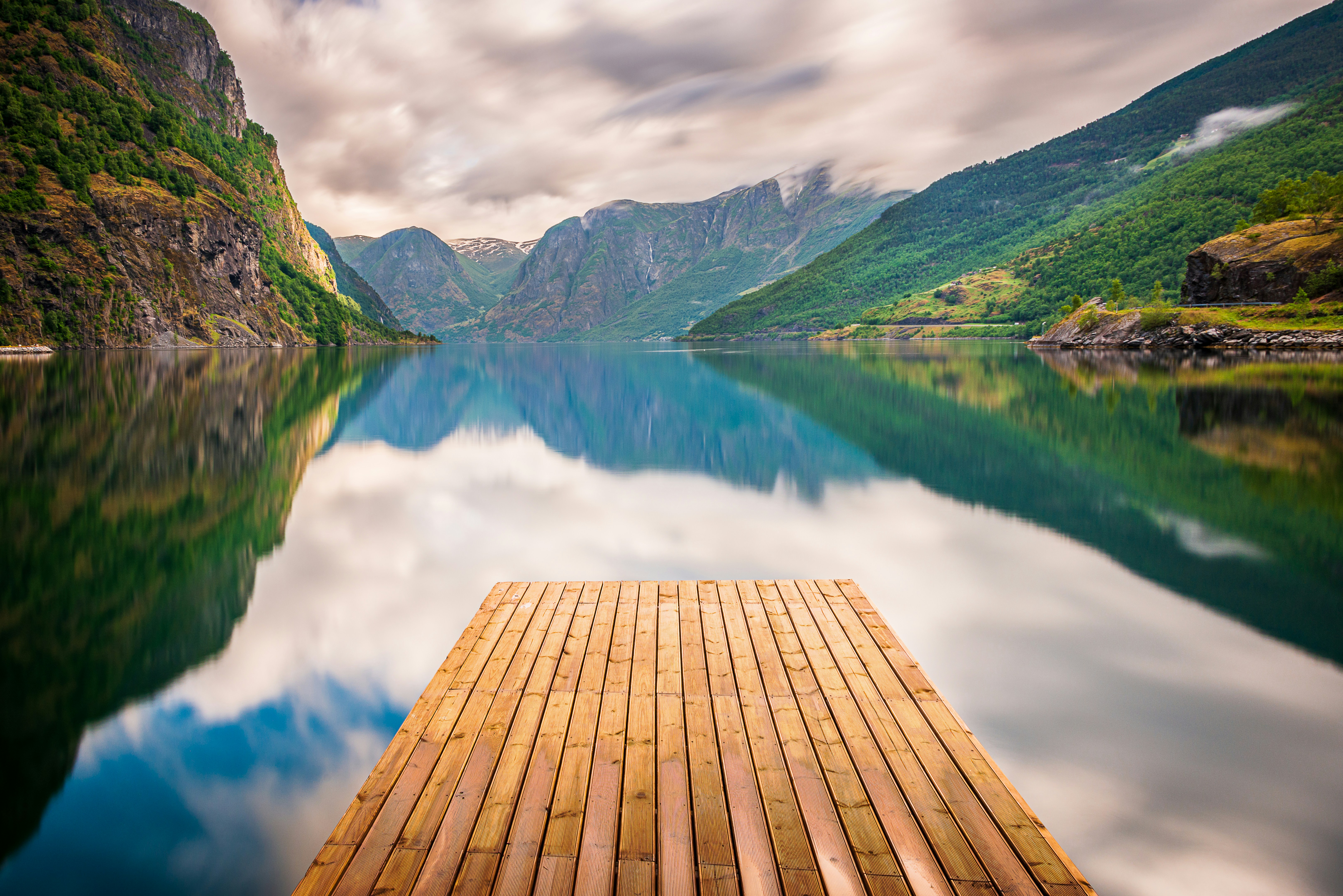 a wooden dock sitting on top of a lake