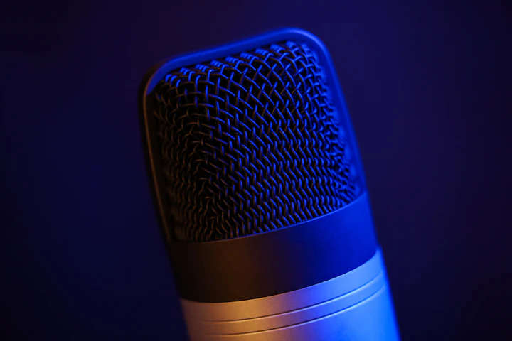 A studio condenser microphone in a darkened recording booth — the quiet setup for a long-form composer interview