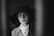 a woman wearing a hat and a trench coat