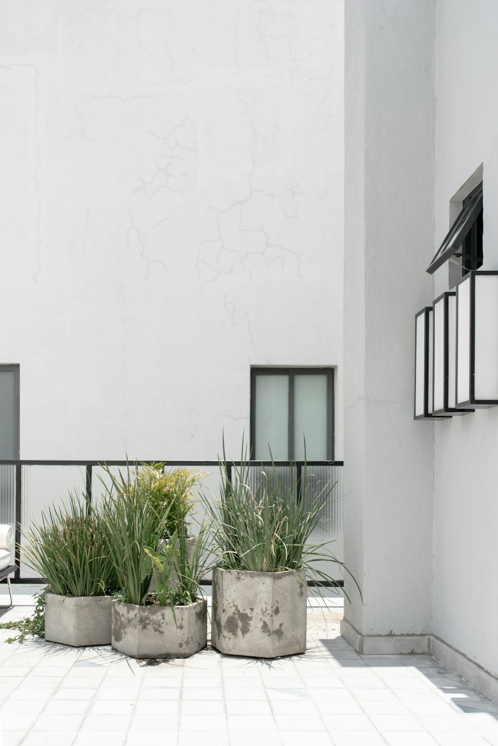 a couple of cement planters sitting next to a building