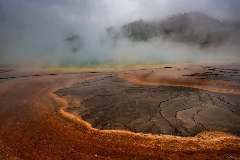 a large body of water with steam rising from it