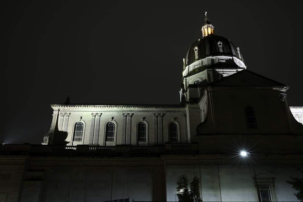 a large building with a clock tower at night