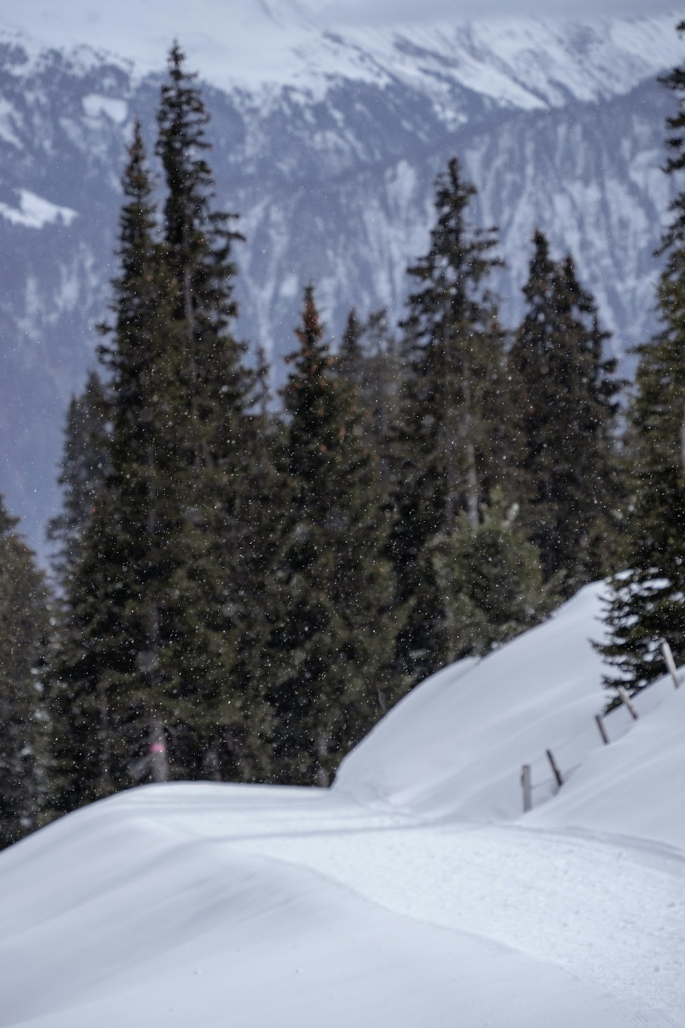 a man riding a snowboard down a snow covered slope