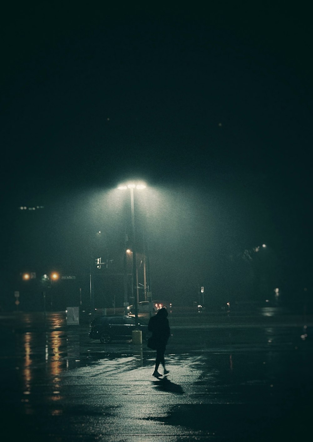 a person walking down a street at night