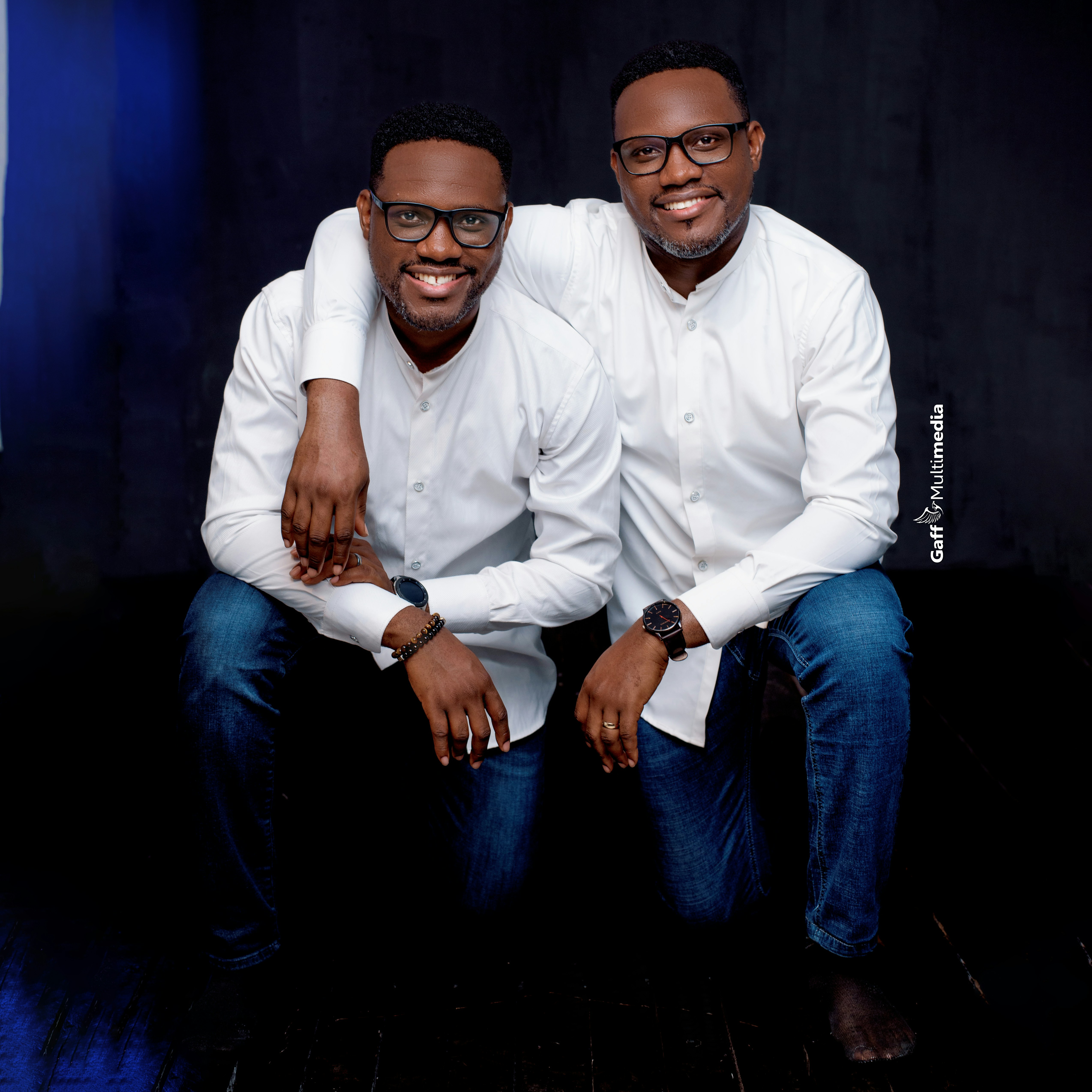 a couple of men sitting next to each other