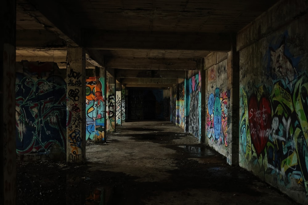 a long hallway with graffiti all over the walls