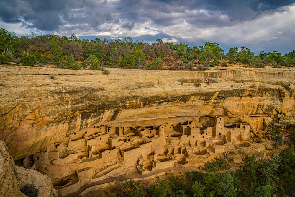 a large cliff with a group of people carved into it