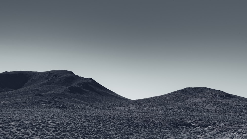 a black and white photo of a mountain range