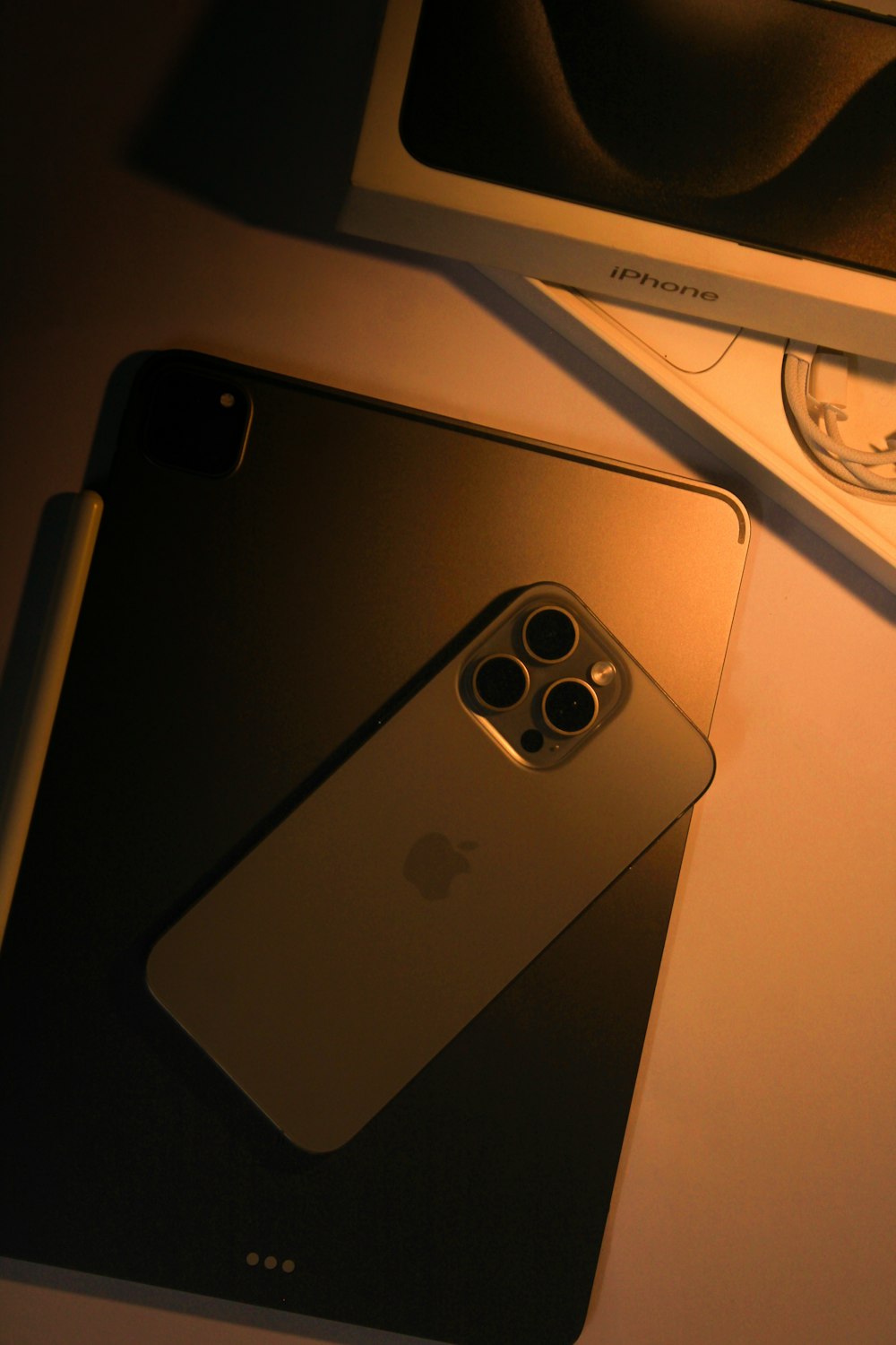 a cell phone sitting on top of a table next to a box