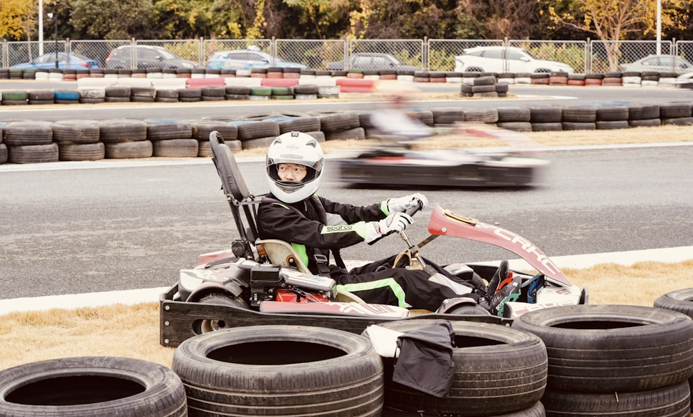 a person in a cart with a bunch of tires