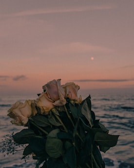 a bouquet of roses sitting on top of a wooden table