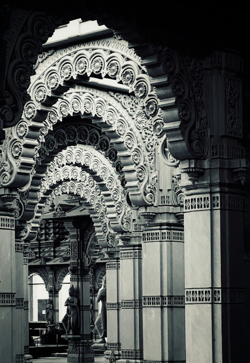 a black and white photo of an ornate archway