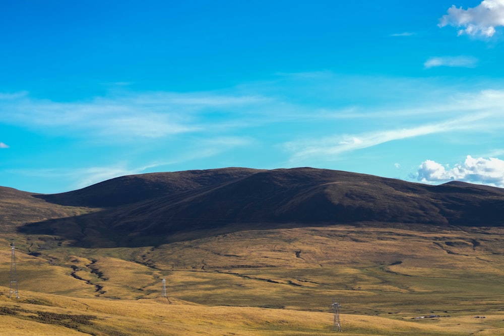 a mountain range with a few clouds in the sky