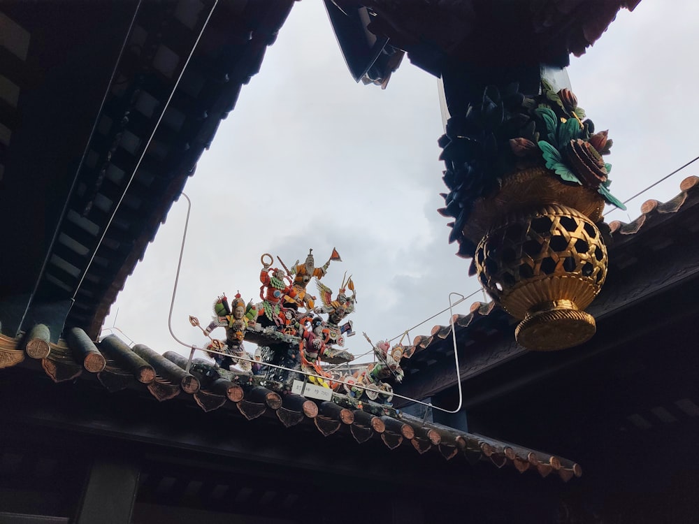 a group of statues on a roof of a building