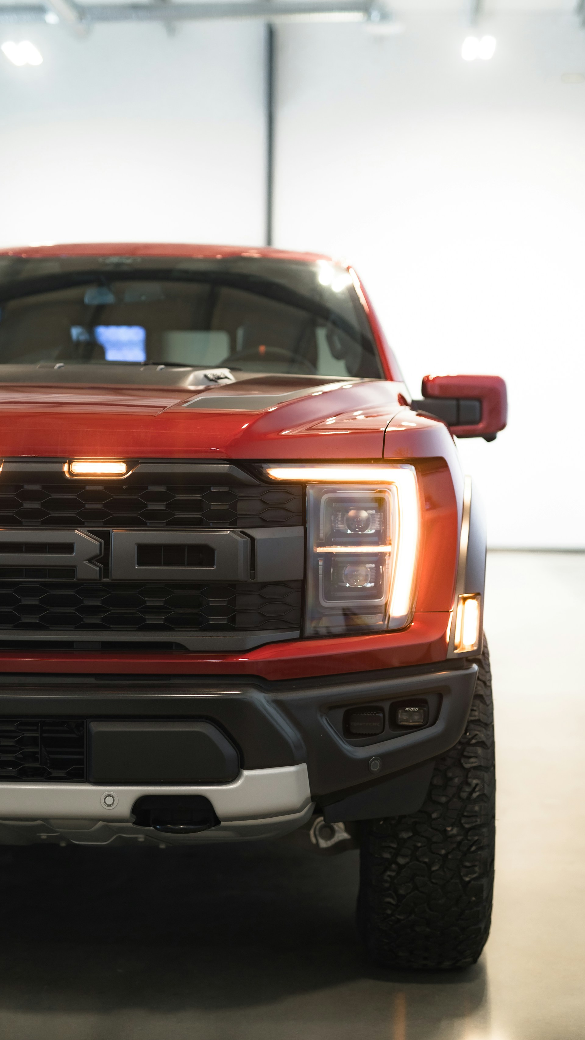 a red pickup truck parked in a garage