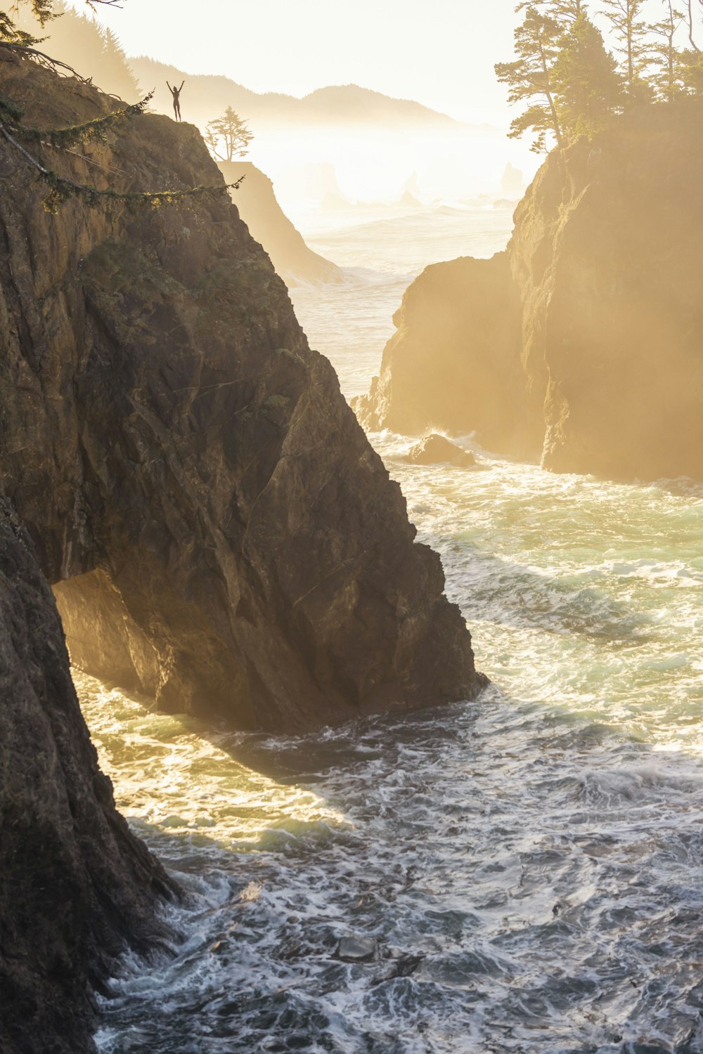 a large body of water near a rocky cliff