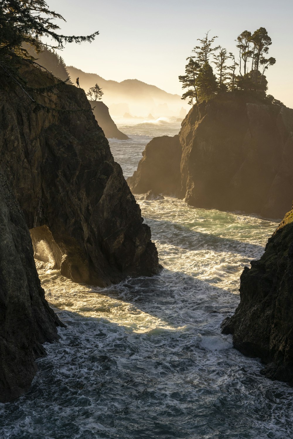 a body of water surrounded by rocks and trees