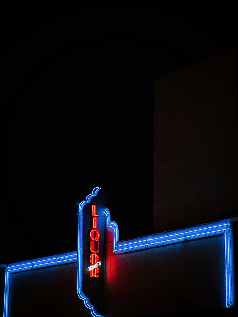 a neon sign on the side of a building