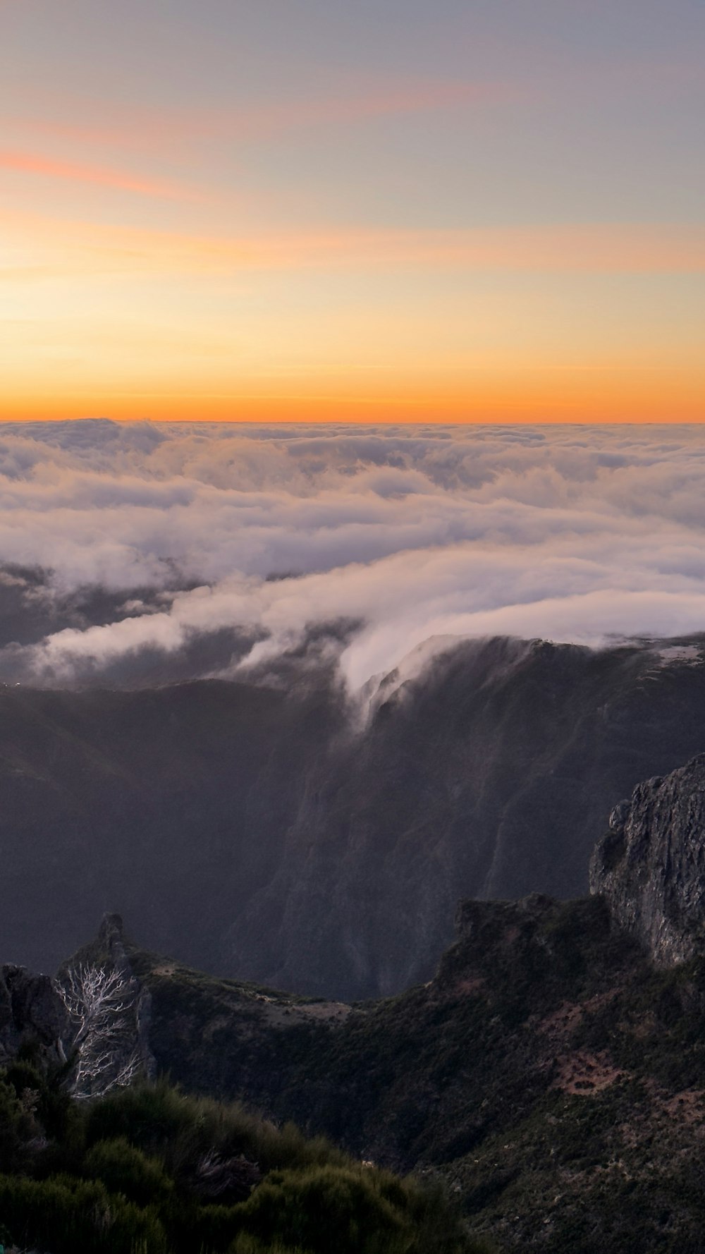 a view of a mountain with clouds in the sky