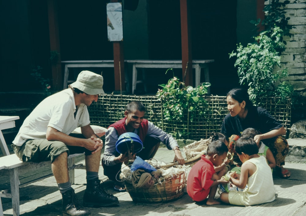 a group of people sitting on a porch next to each other